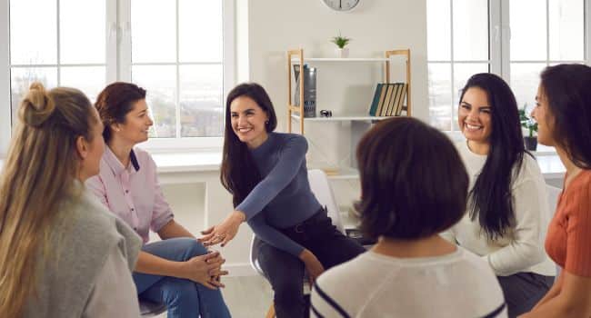A group of women in a supportive therapy circle, illustrating how cognitive therapy can help manage and reduce fear.
