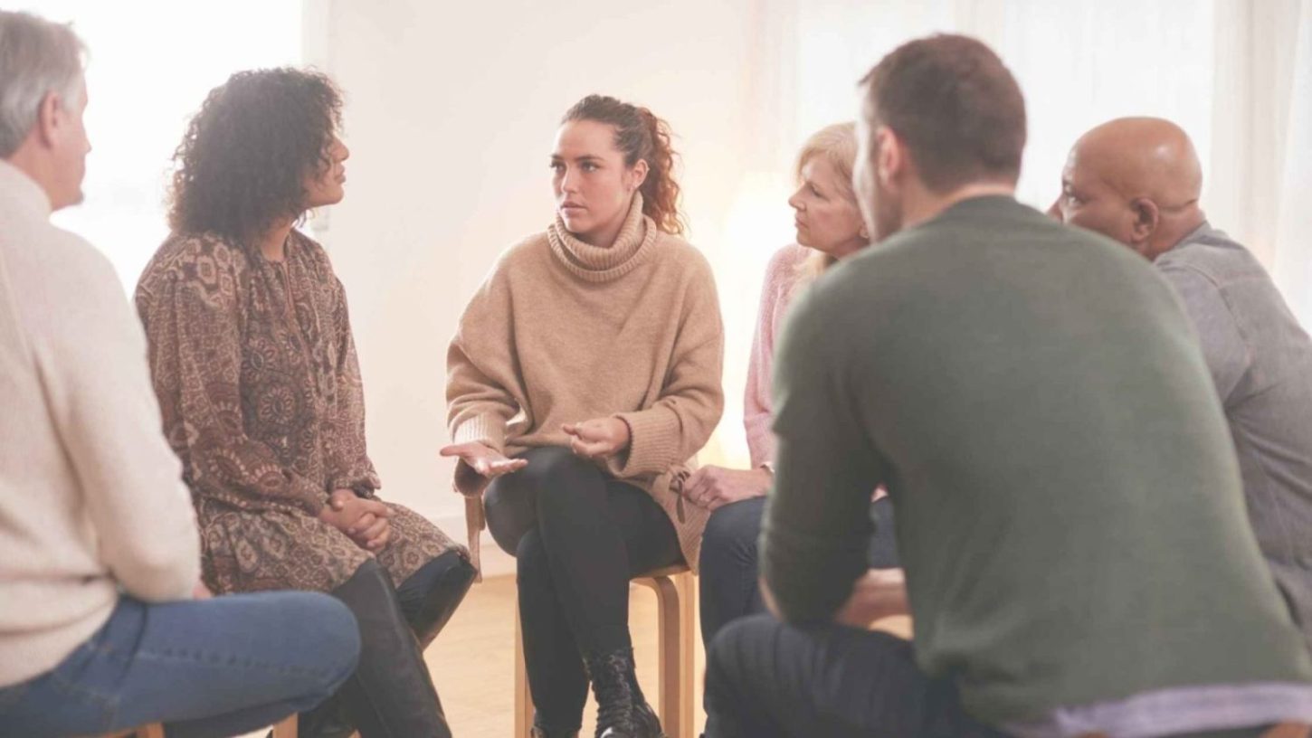 Family members and counselors seated in a circle, discussing recovery at an Arizona alcohol rehab center.