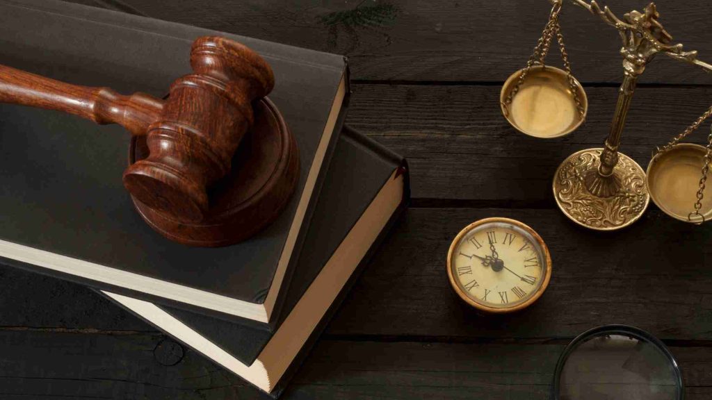 A judge’s gavel, legal books, and scales of justice on a desk, symbolizing how FMLA protections are upheld by law.